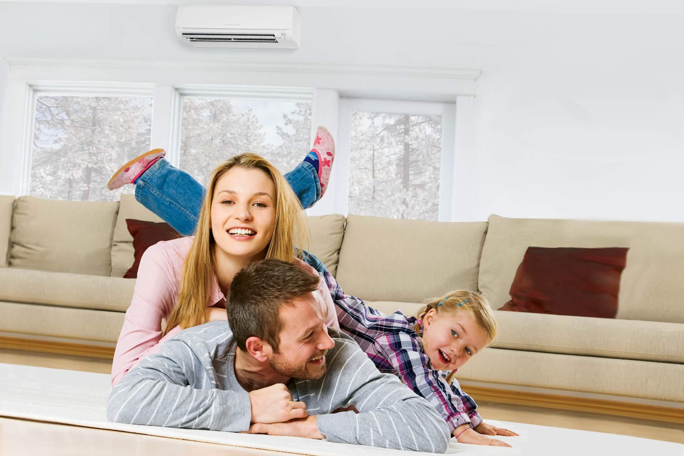 A happy family lying in the living room smiling and playing